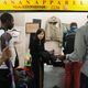 Traders discuss a shipment of jeans at Canaan Market in Guangzhou, China.